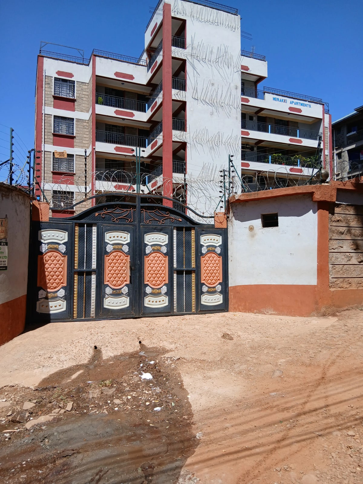 Multi-story residential building with decorative compound gate