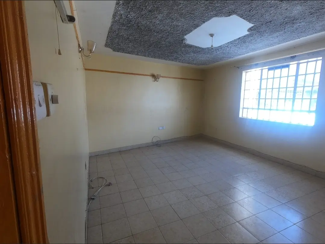 Empty living room with tiled floor and large window