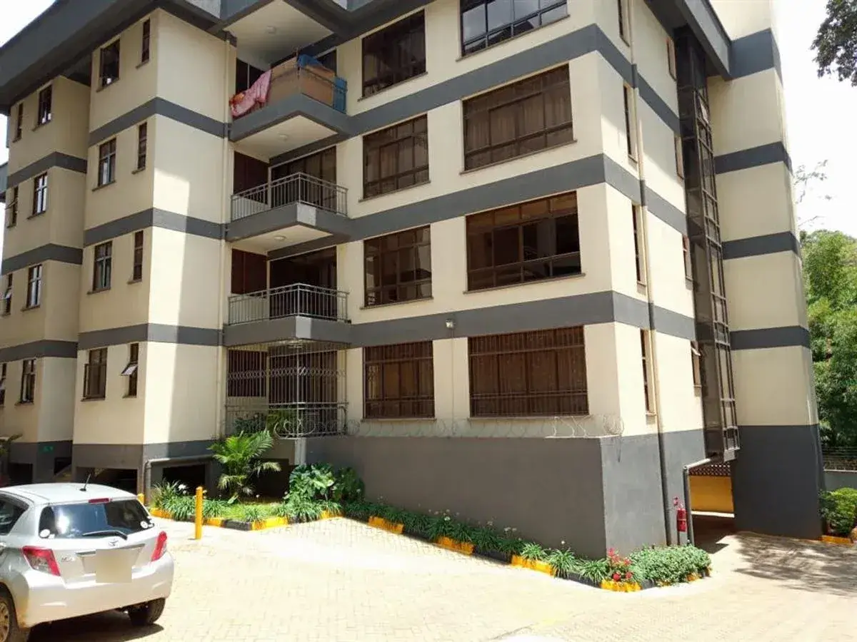 Modern multi-story apartment building with cream and dark facade