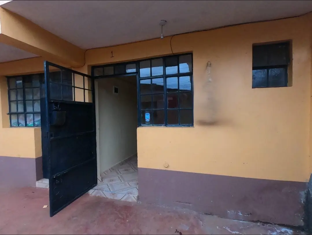 Building entrance with blue door and tiled floor