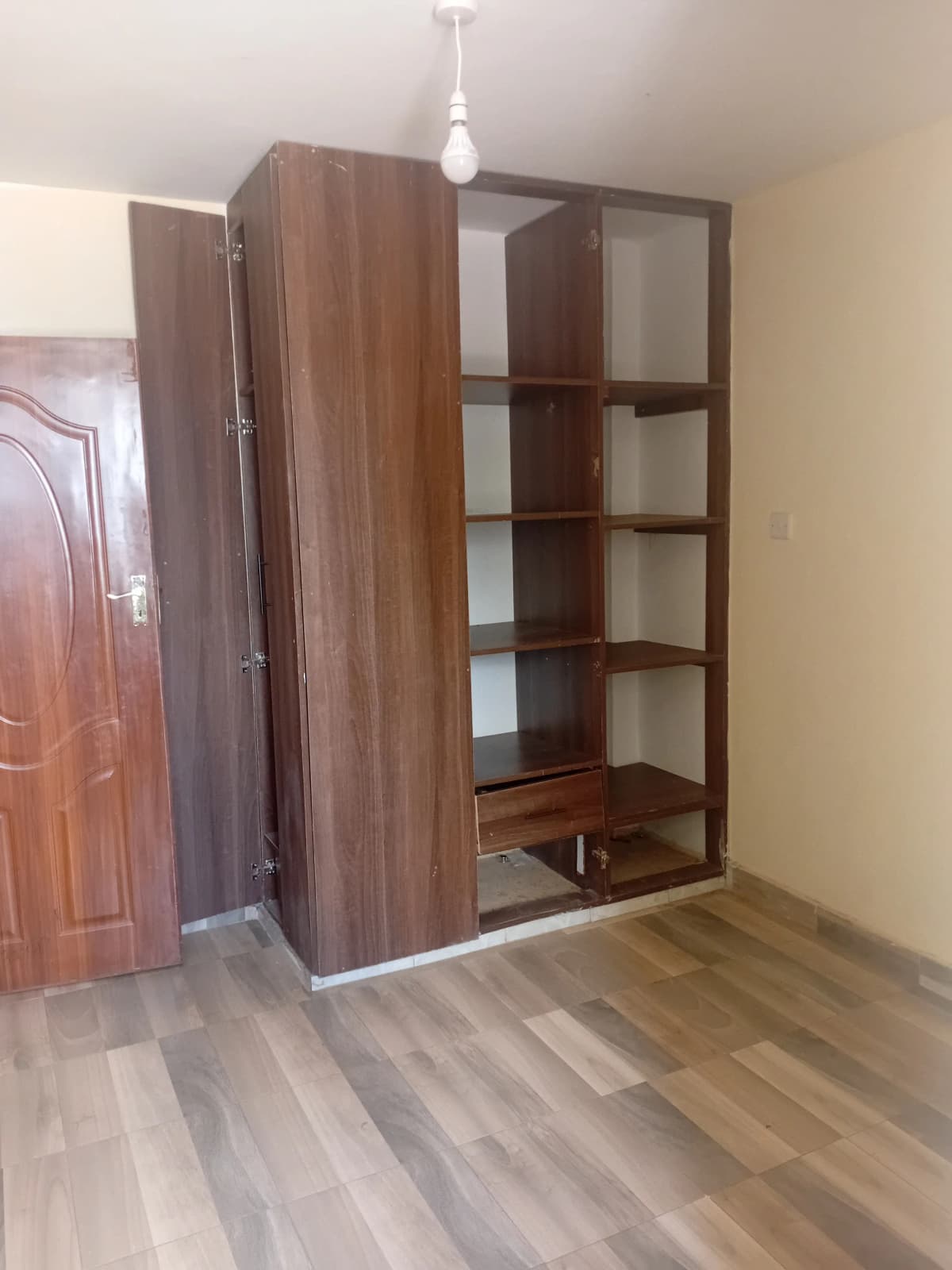 Bedroom with wooden wardrobe and shelving unit