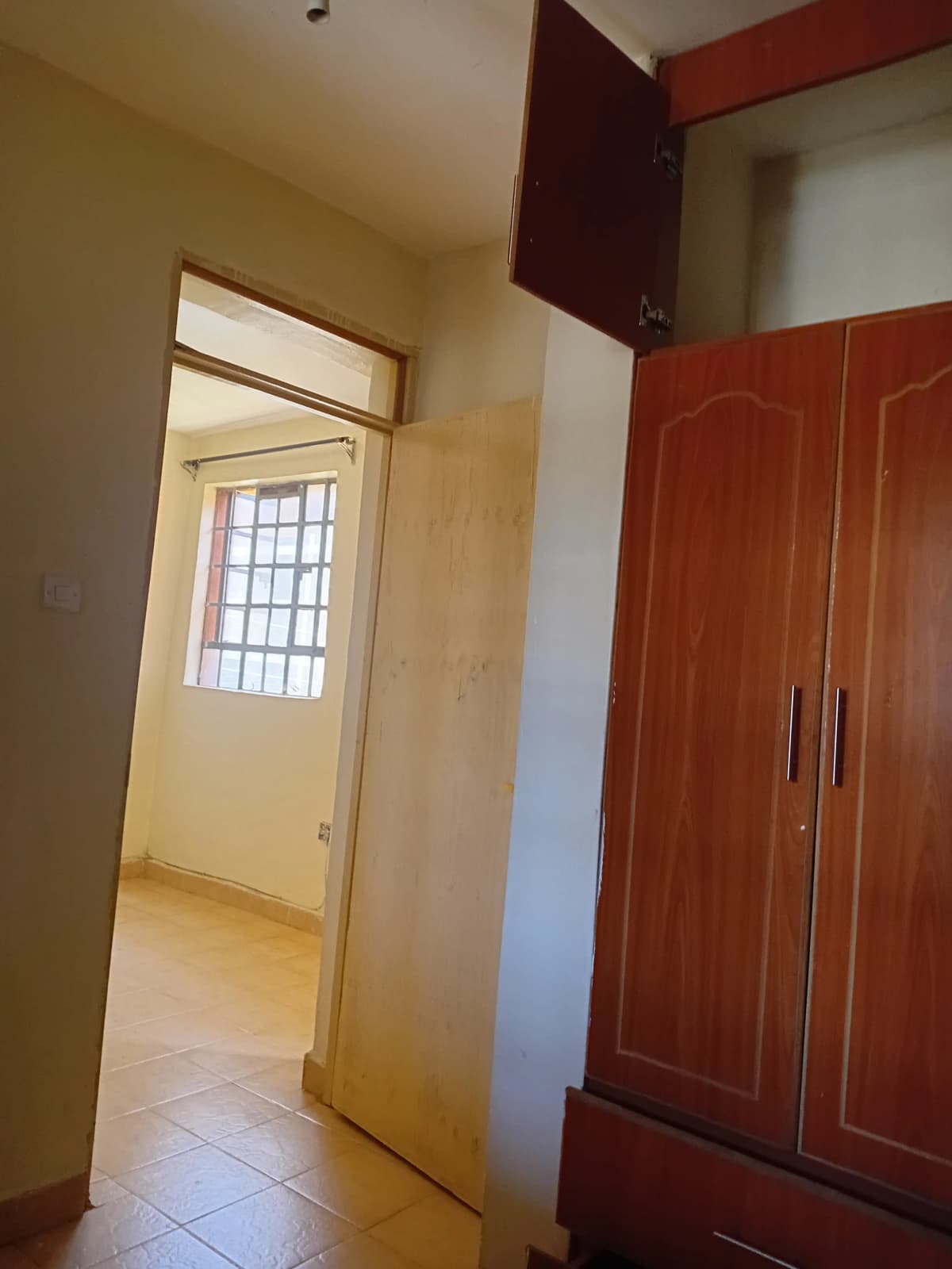 Bedroom with built-in wardrobe and entry door