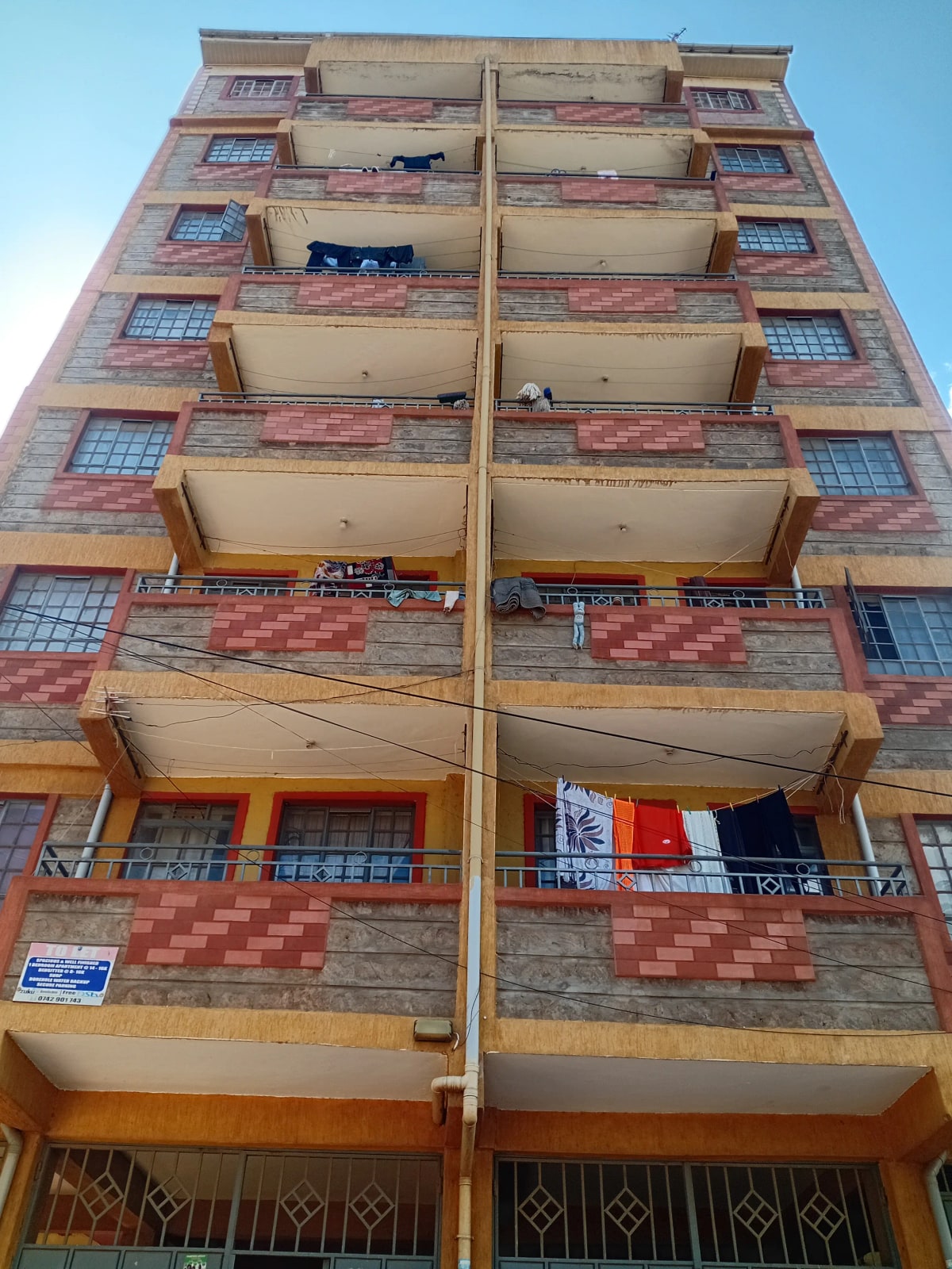 Multi-story residential building facade with balconies and windows