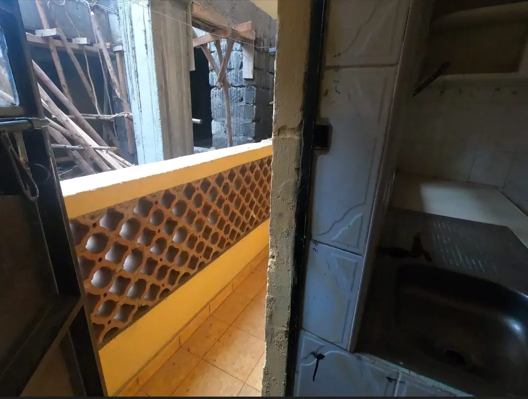 Building corridor with yellow-painted wall paneling and door