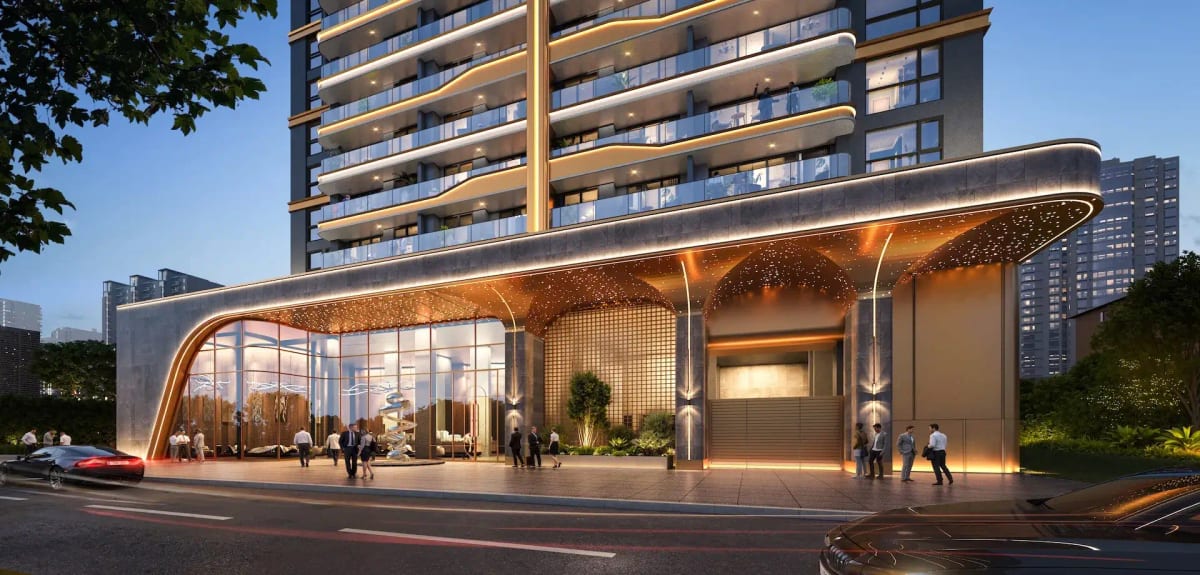 Luxury high-rise building facade with illuminated entrance canopy at dusk