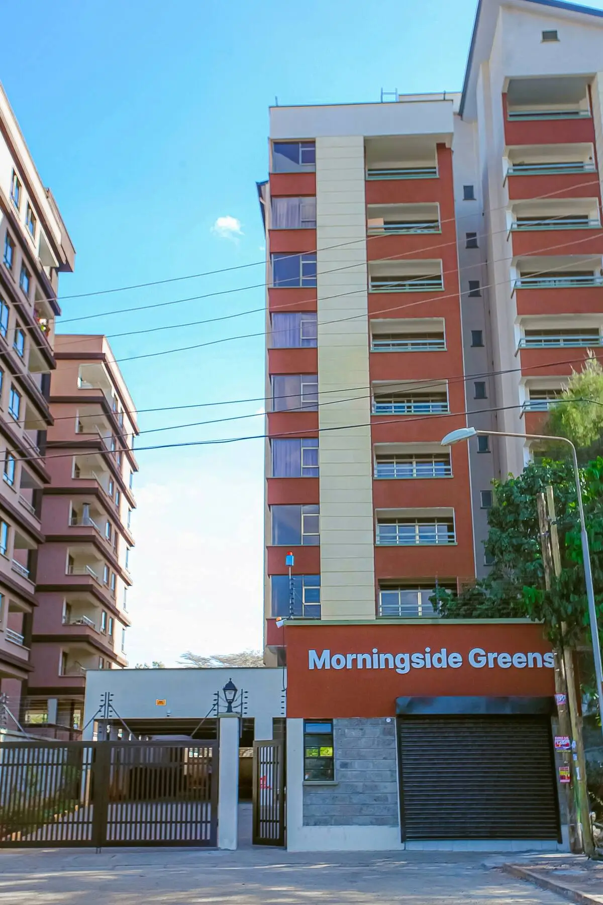 Modern multi-story residential building with orange balconies