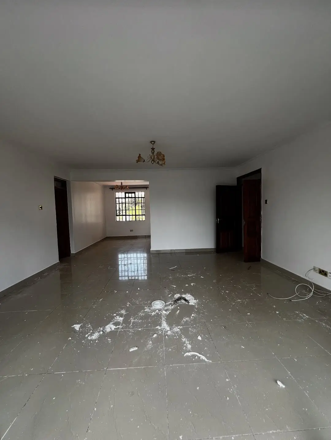 Empty living room with polished concrete floor, minimal finishes