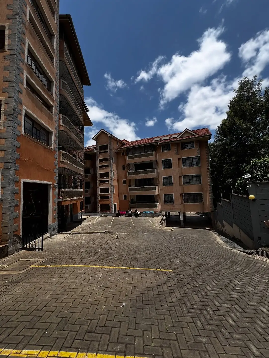 Residential compound courtyard with brick paving and apartment buildings