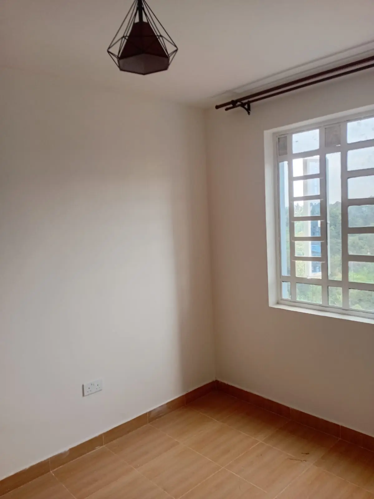 Minimalist bedroom with wooden floor and large window