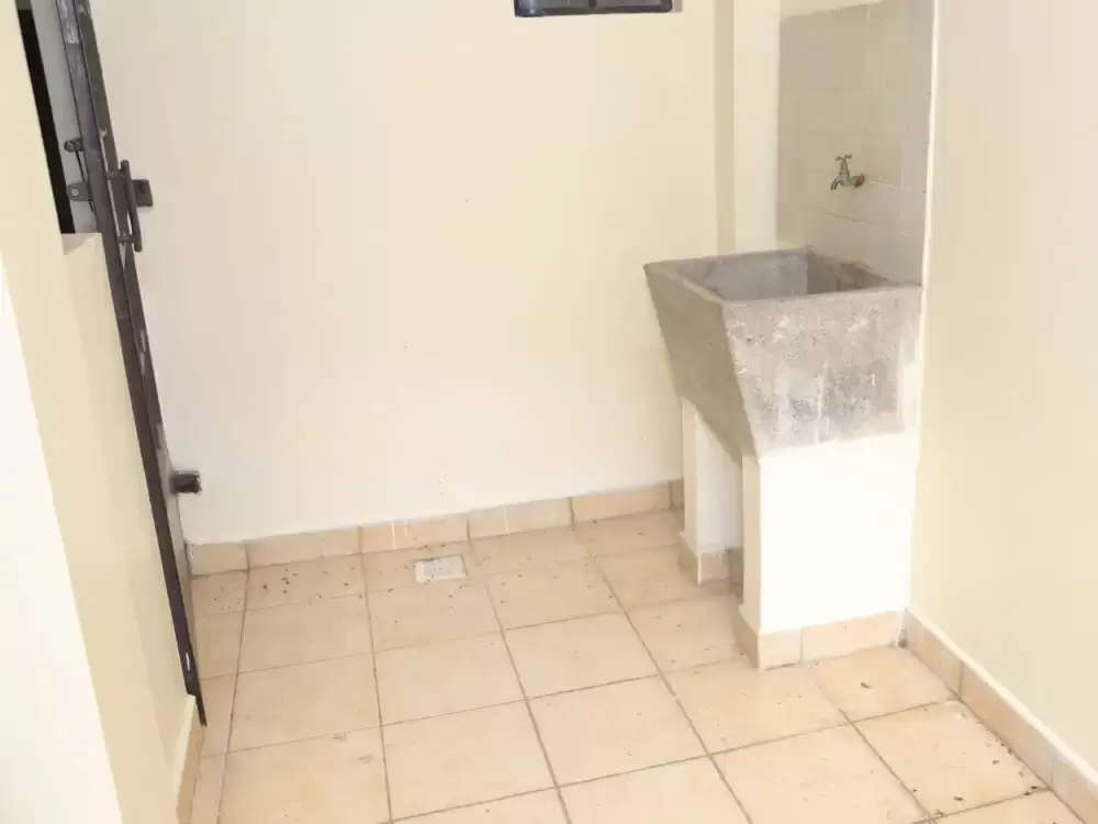 Utility room with washing machine and tiled flooring