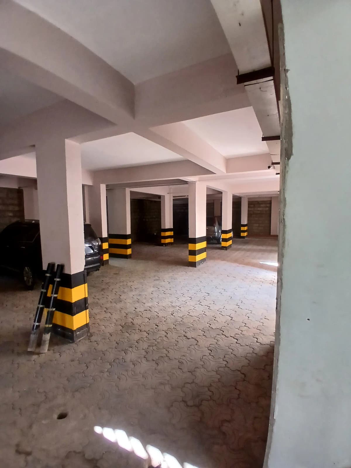 Basement parking level with concrete floor and support columns