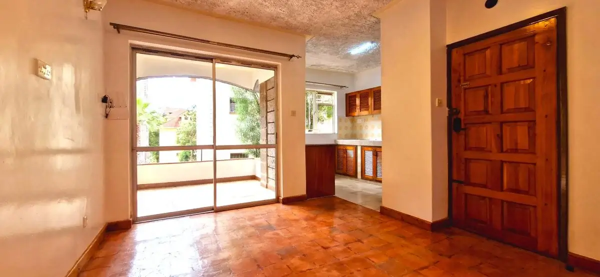 Spacious living room with sliding glass doors opening to balcony