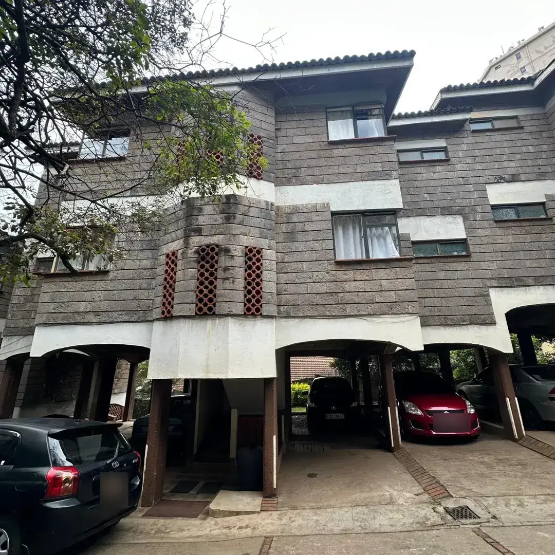 Modern brick facade with ground-level carport parking