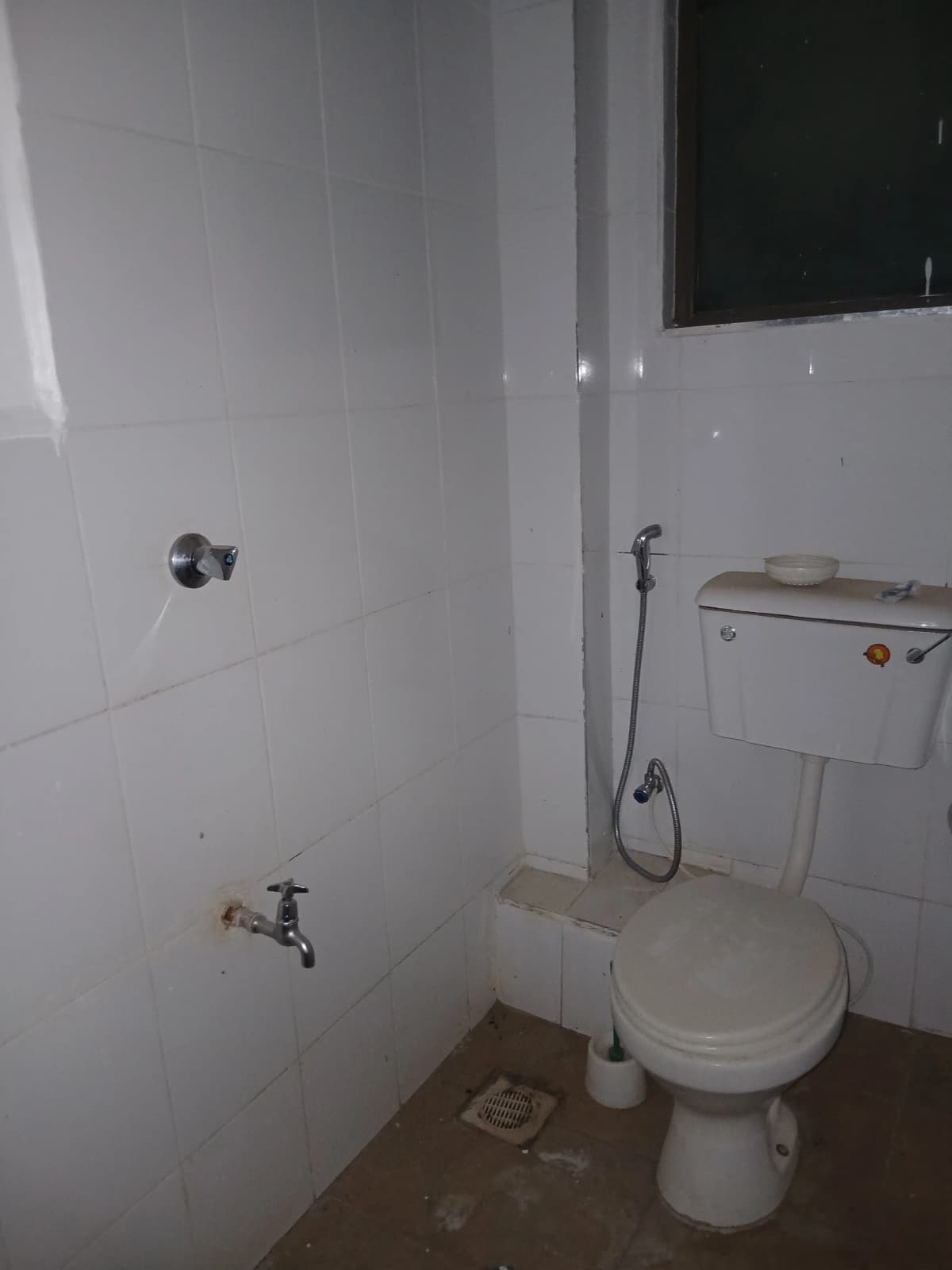 Basic bathroom with toilet, sink, and shower fixtures