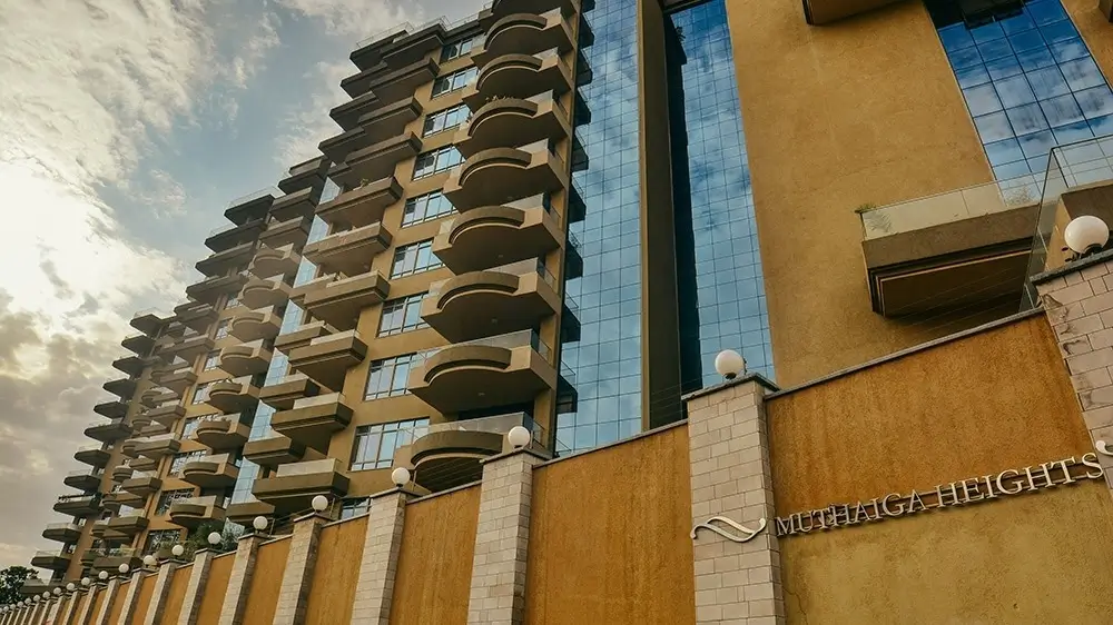 Multi-story residential building facade with balconies and gate