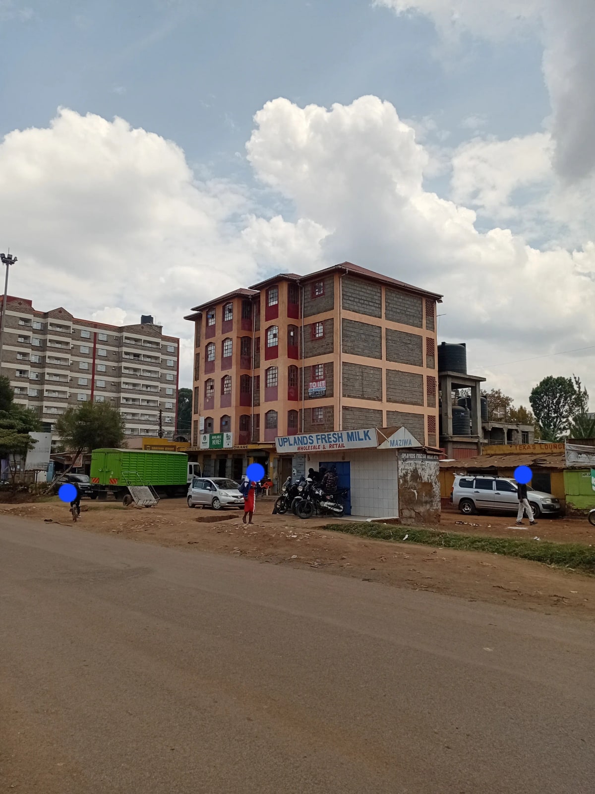 Multi-story residential building facade with red brick construction