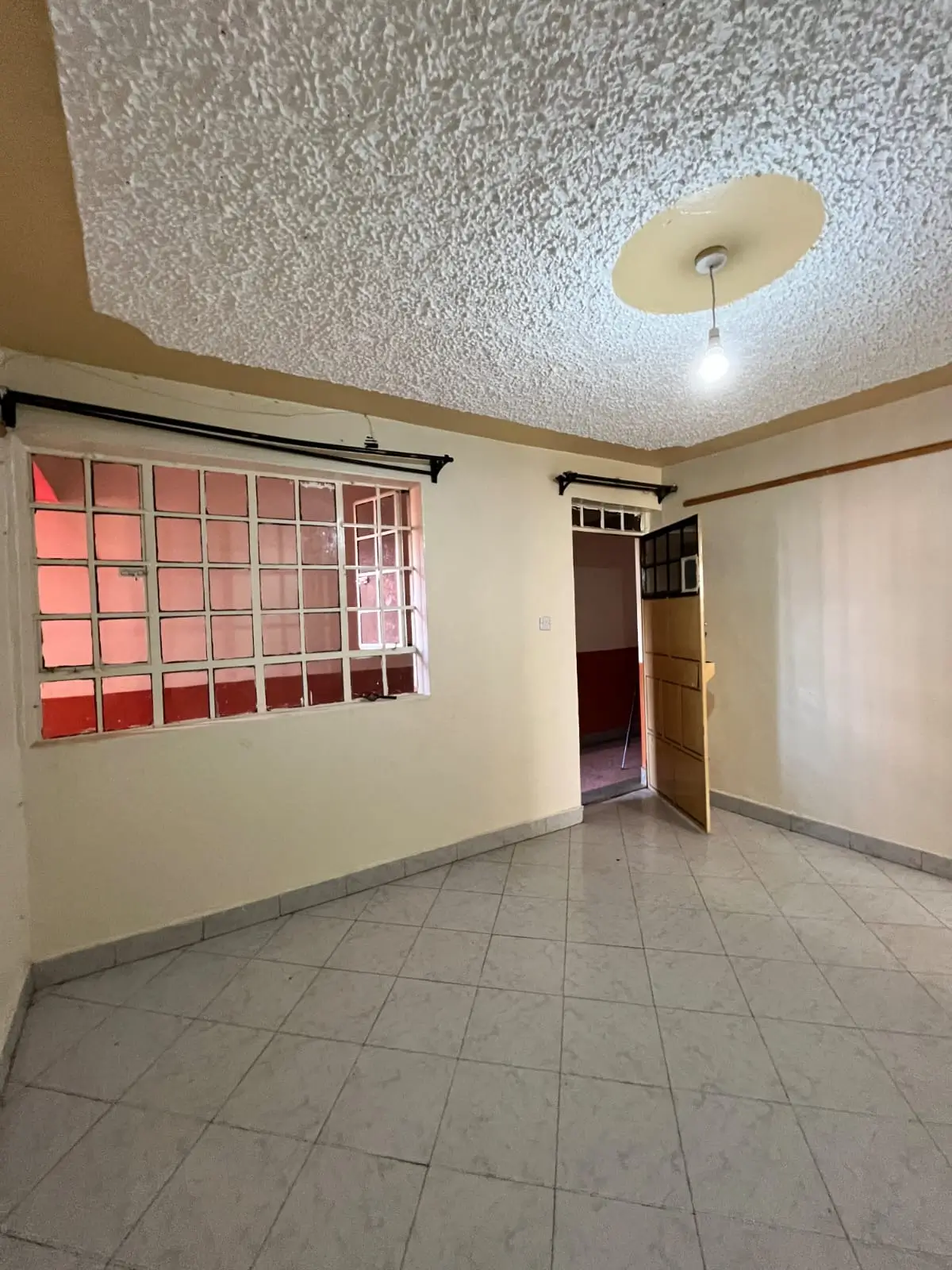Empty living room with tiled floor and colored window blocks