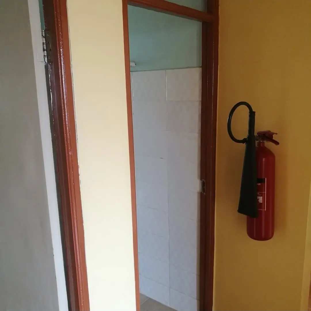 Building corridor with fire extinguisher and mirrored door