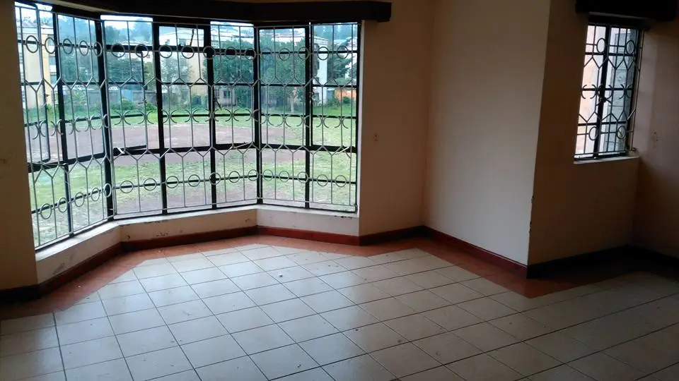 Spacious living area with curved bay windows overlooking grounds