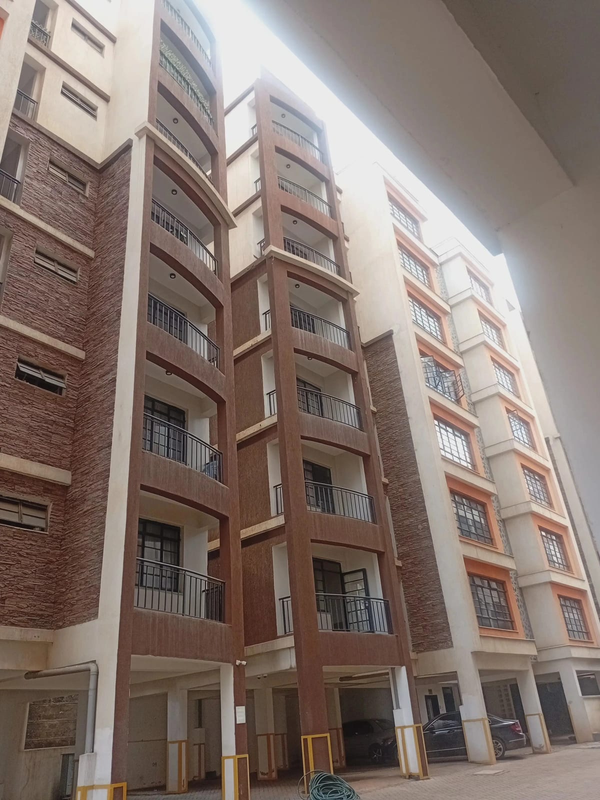 Modern residential apartment building facade with brick and cream finish