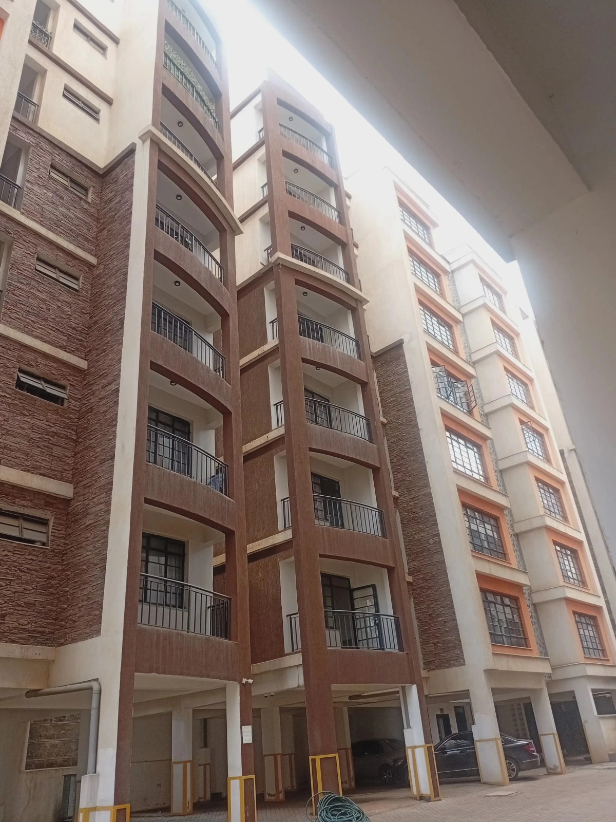 Modern residential apartment building facade with brick and cream finish