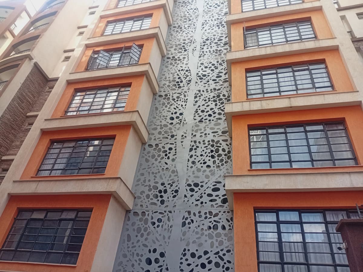 Modern apartment building facade with orange-trimmed windows