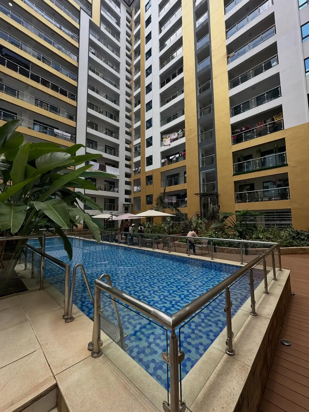 Residential swimming pool with blue tiling and metal railings