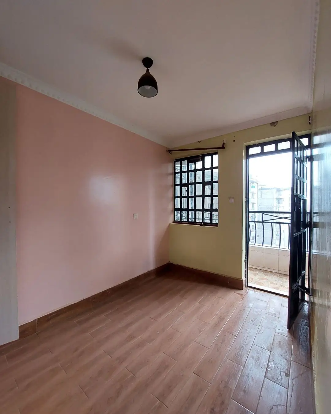 Bright bedroom with balcony access and wooden flooring