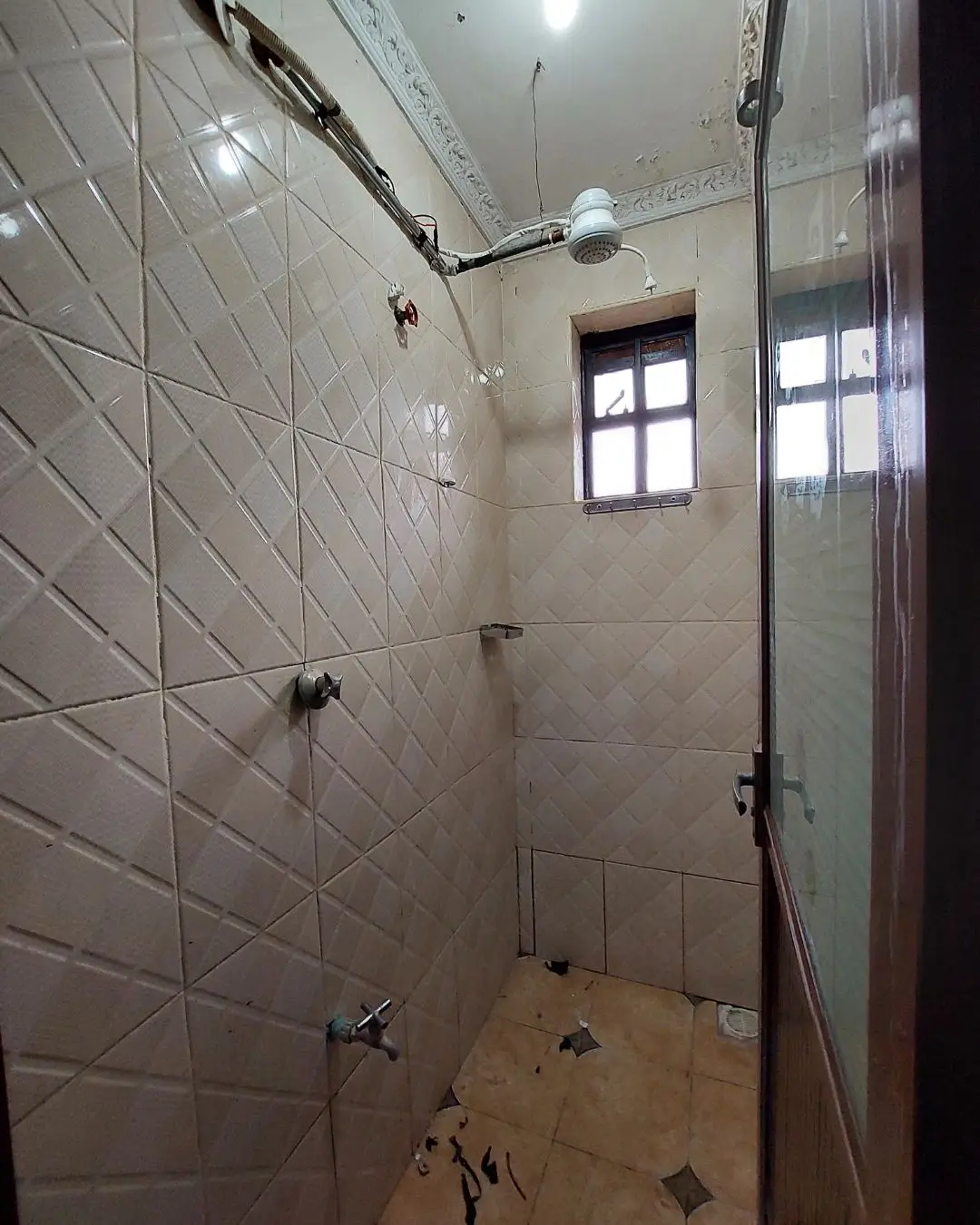 Modern bathroom with white tile shower enclosure and window