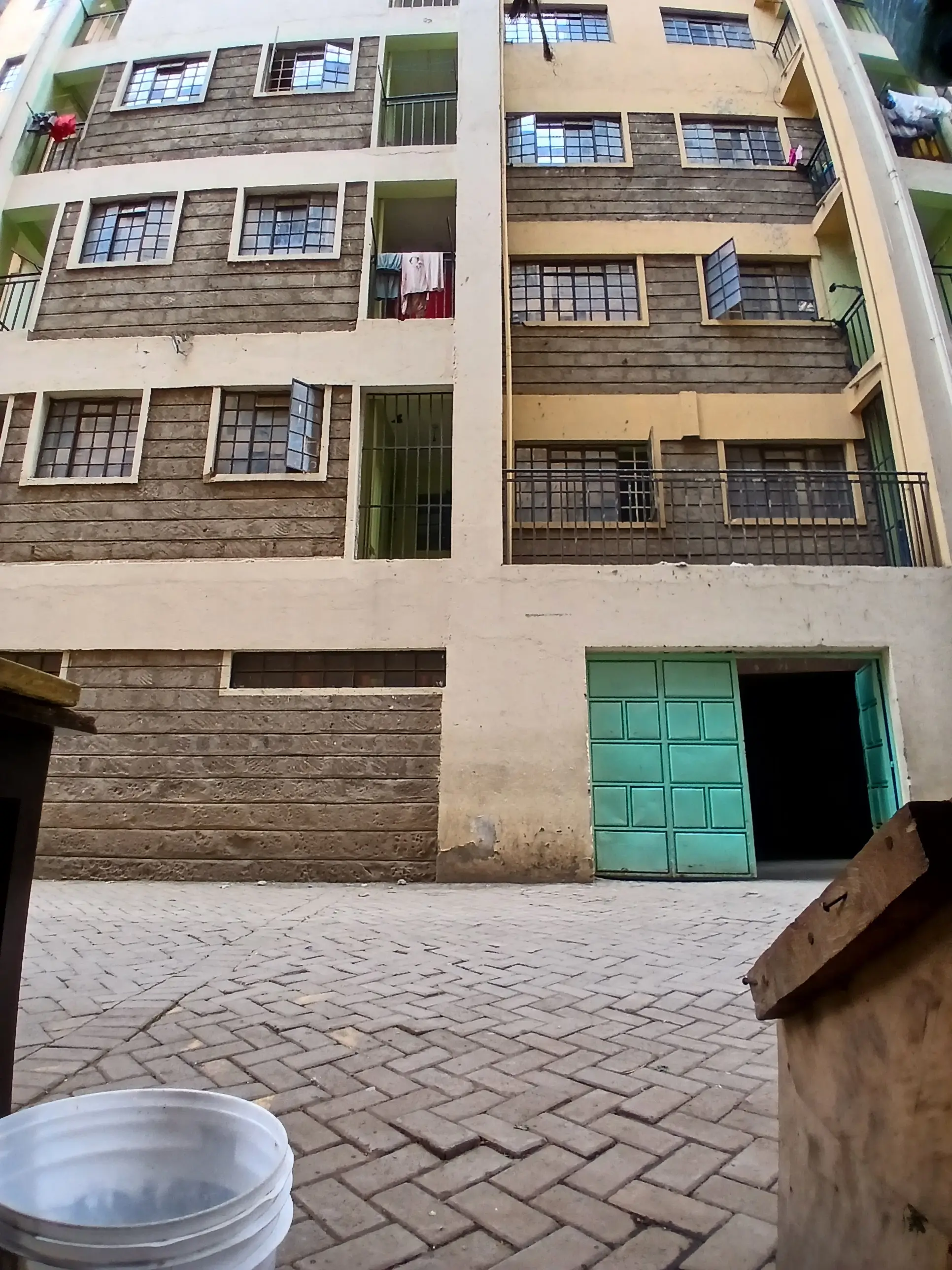 Multi-story residential building facade with ground-level parking entrance
