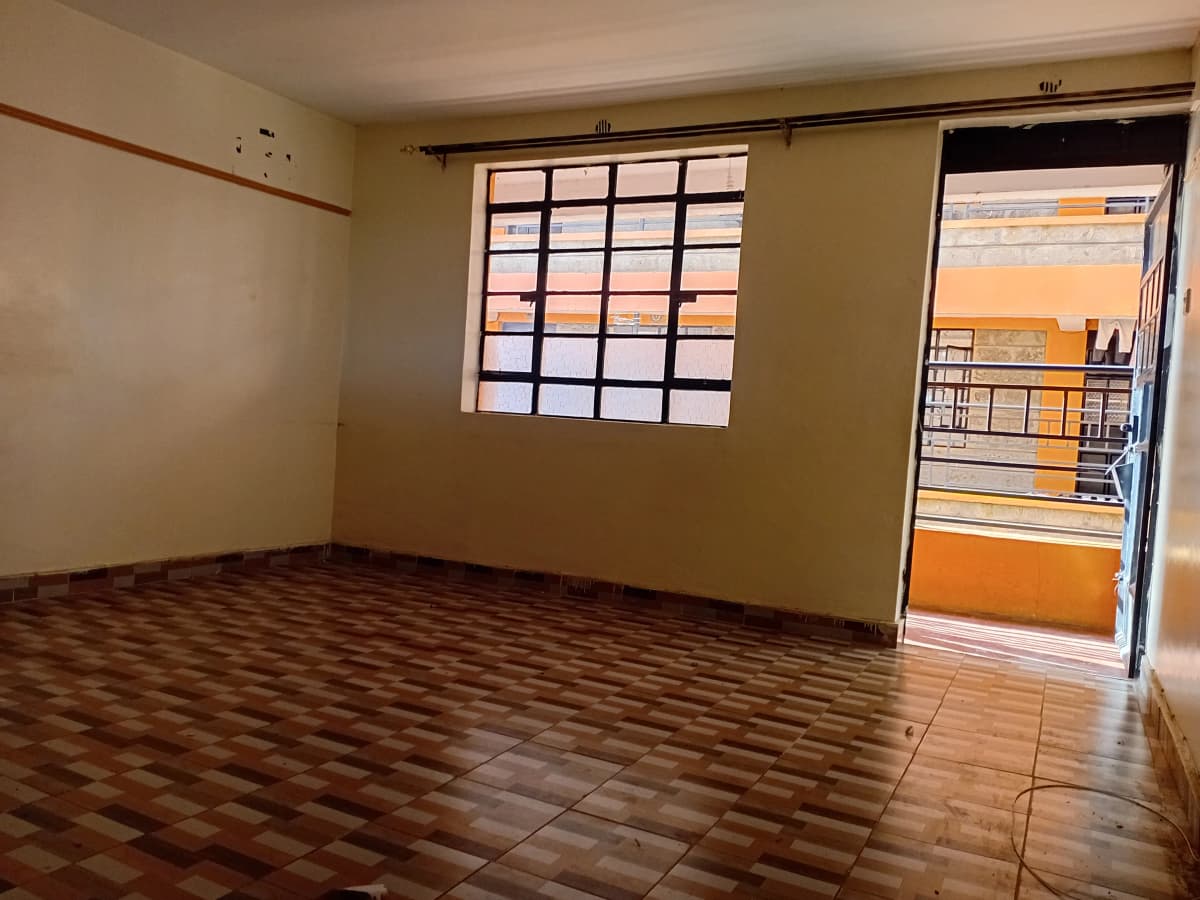 Empty living room with wooden floor and glass door balcony