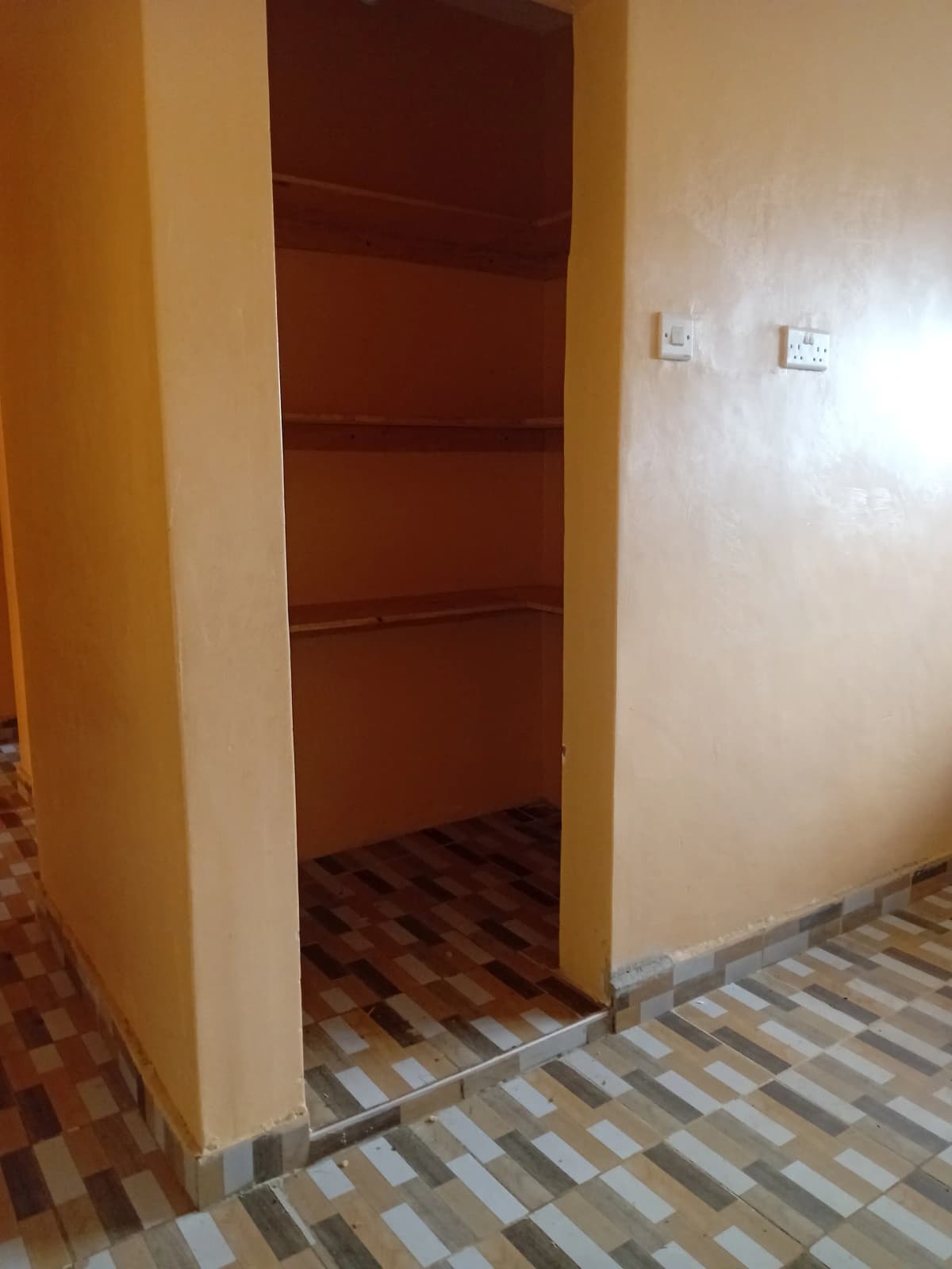 Empty shelved storage closet with burgundy interior shelving
