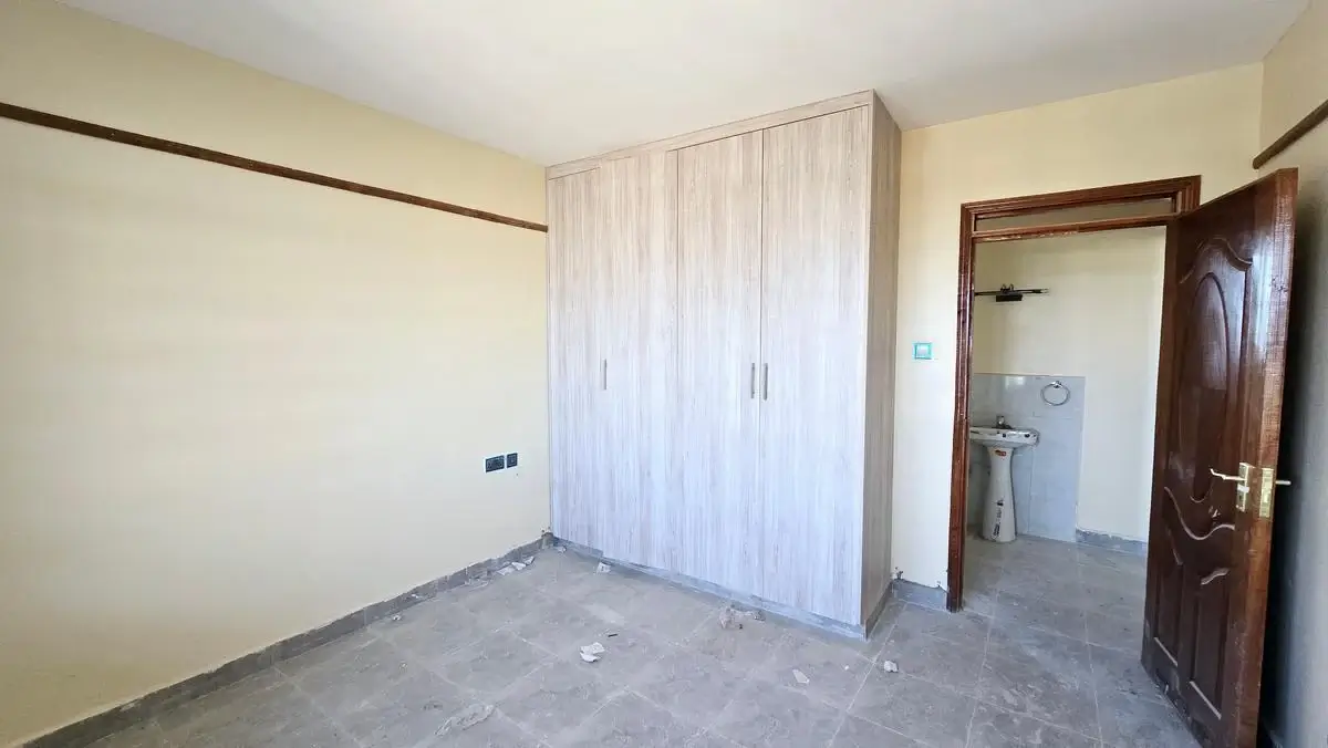 Unfurnished bedroom with built-in wardrobe and en-suite access