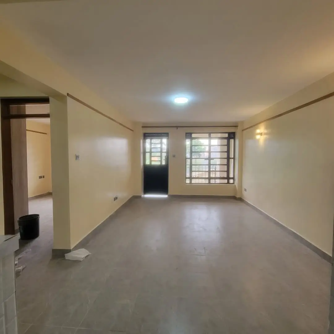 Spacious empty living room with grey concrete flooring