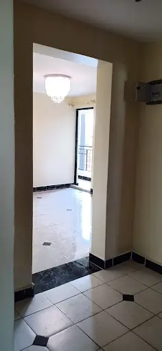 Hallway with tiled flooring and ceiling light fixture
