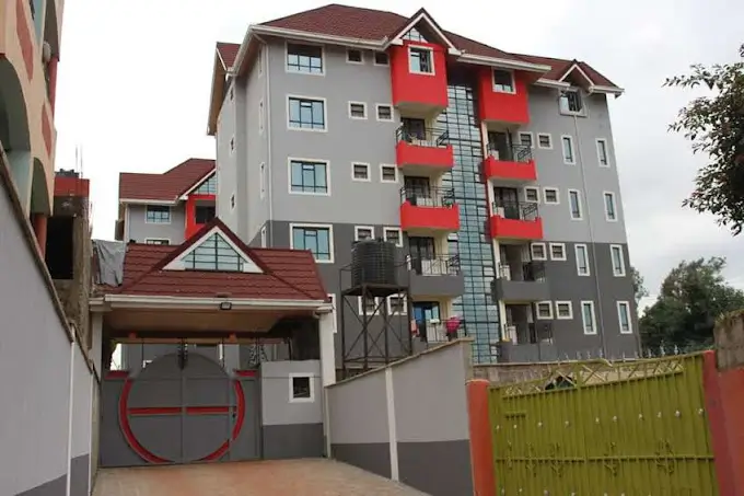 Multi-story residential apartment building with red balconies