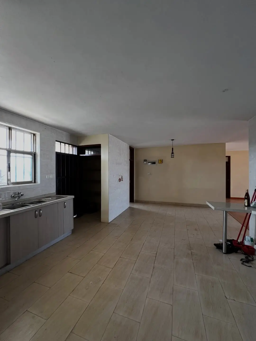 Open-plan kitchen and living space with tile flooring