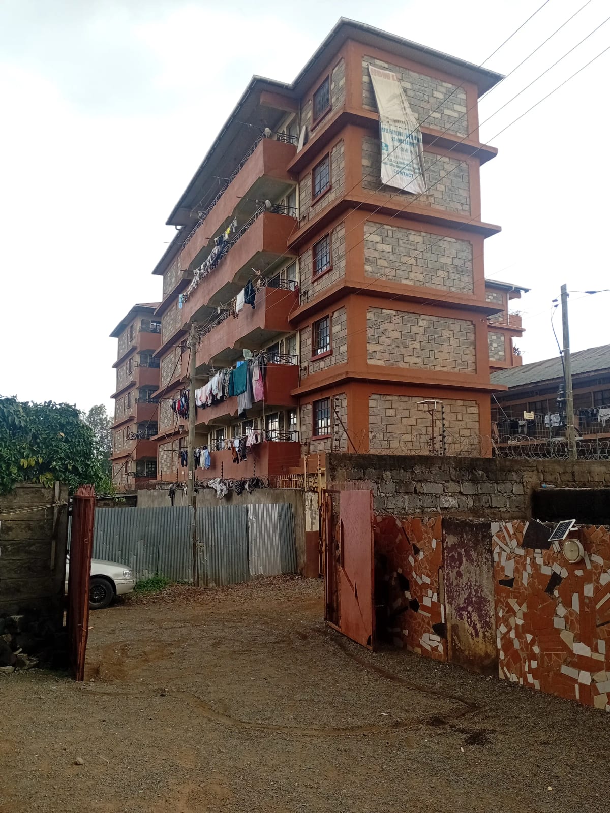 Multi-story residential building with red brick and stone facade