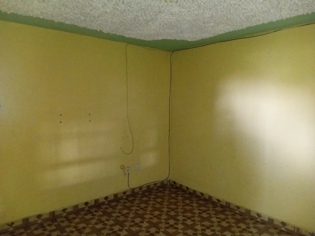 Empty room with yellow walls, under construction or renovation