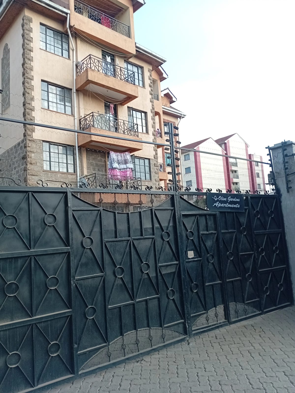 Multi-story residential building with metal gate entrance