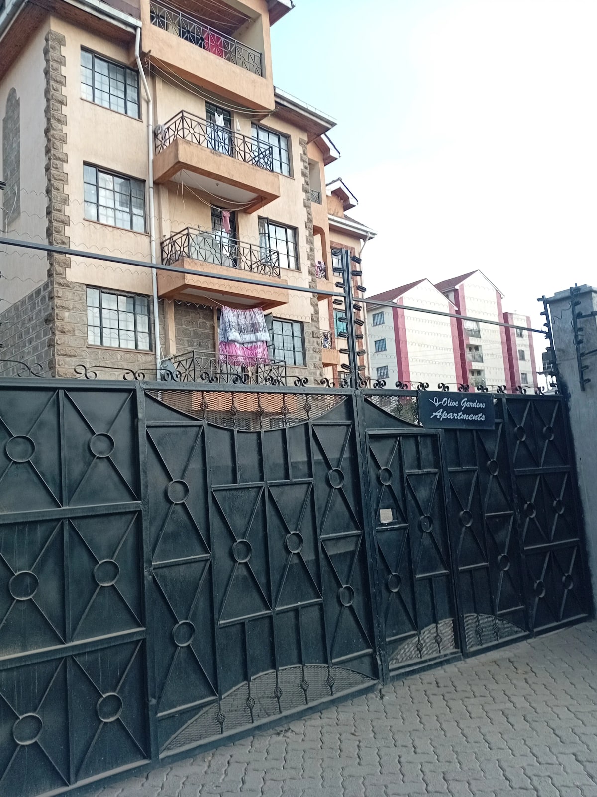 Multi-story residential building with metal gate entrance