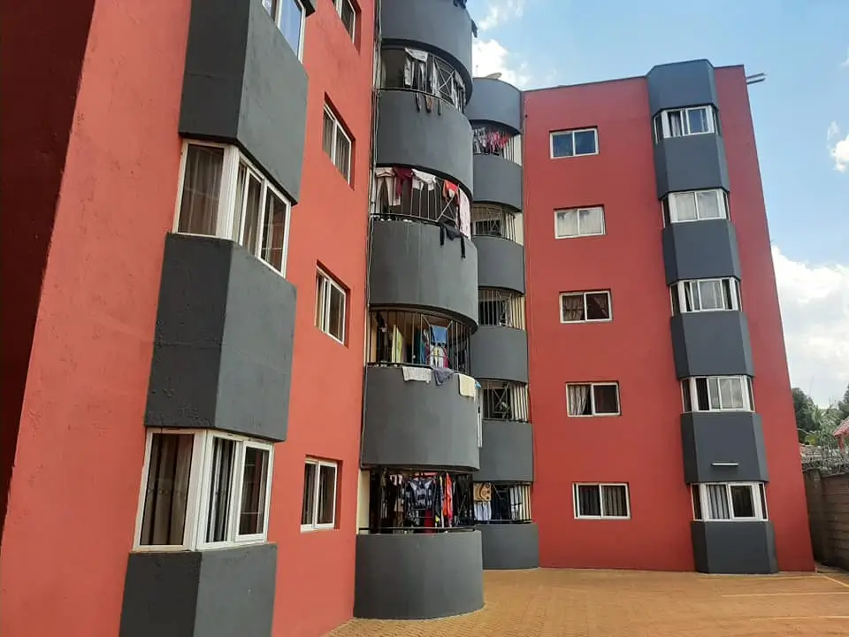 Modern apartment building facade with red and gray panels