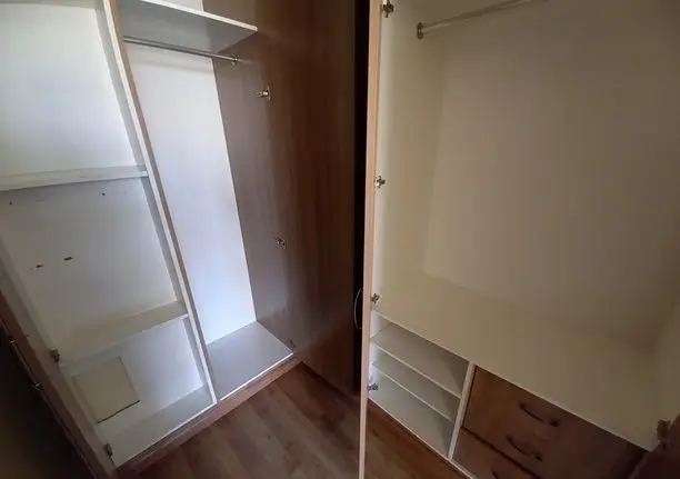 Empty built-in pantry with shelving and sliding glass door