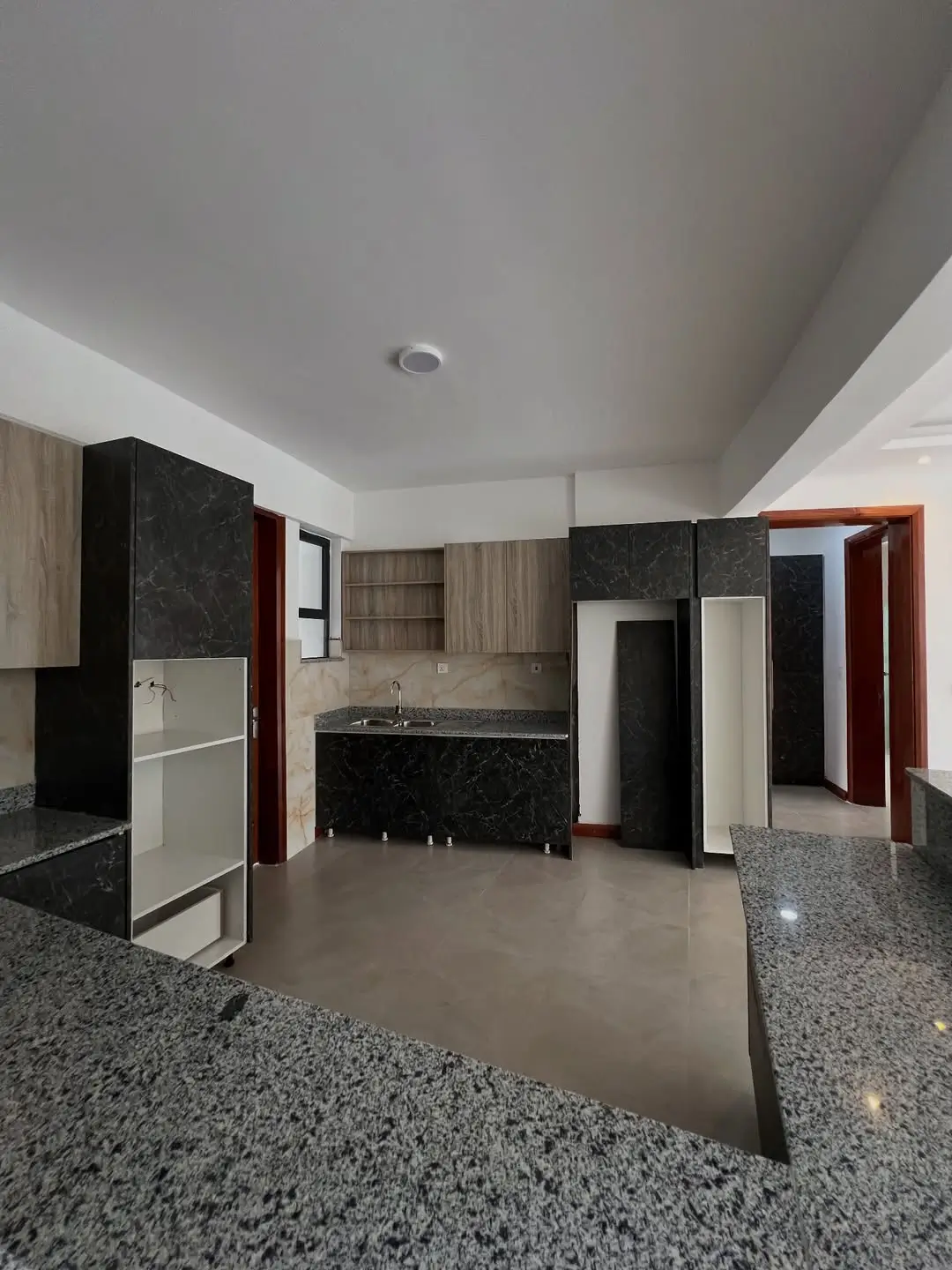 Modern kitchen with black cabinetry and granite countertops