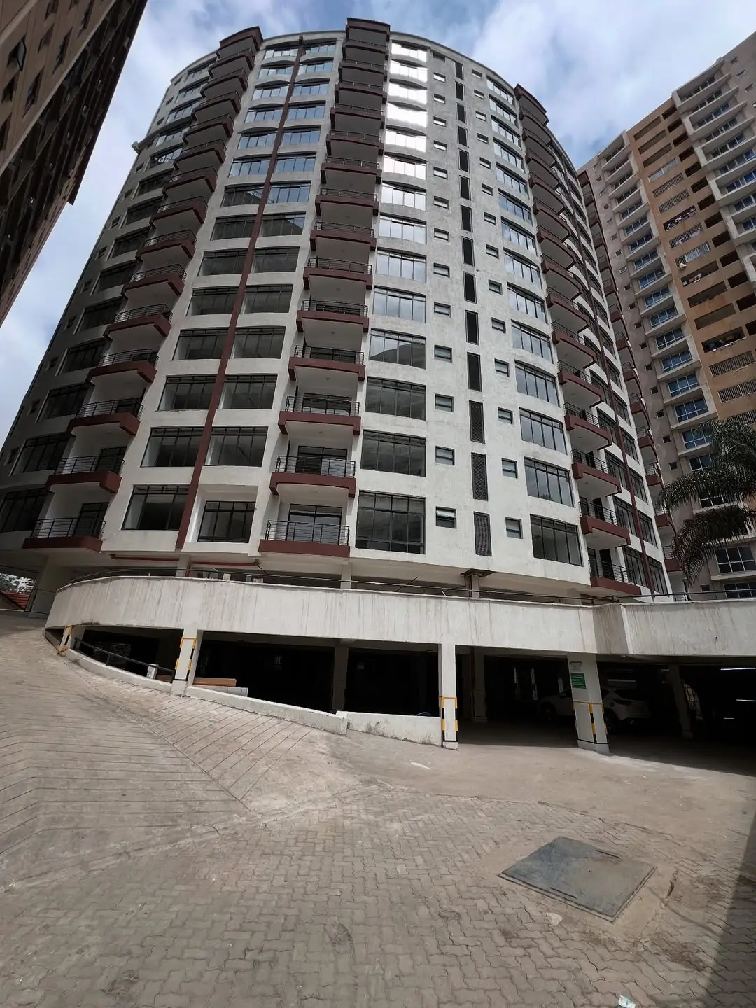Modern multi-story residential building with underground parking garage