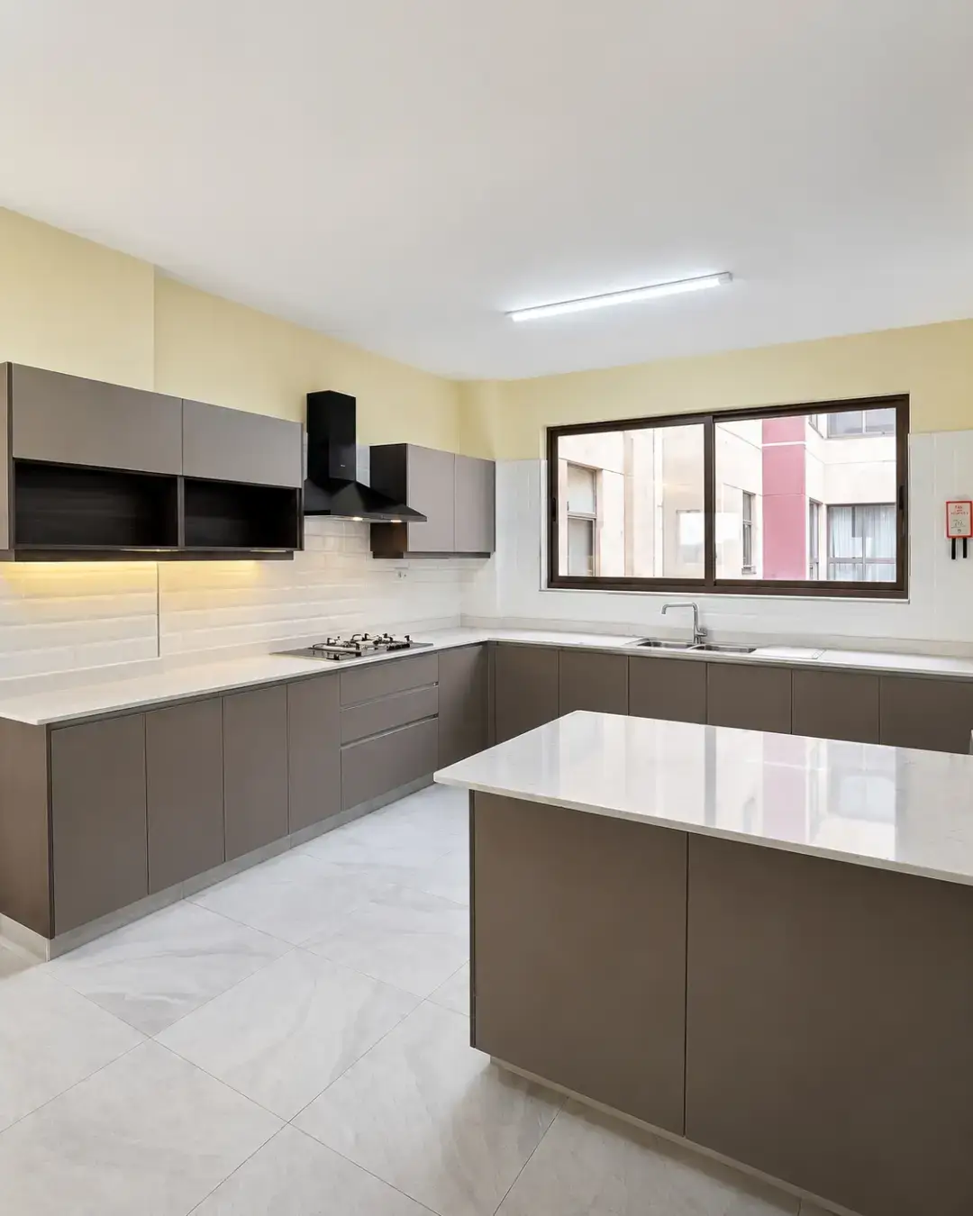 Spacious U-shaped kitchen with island and grey cabinetry