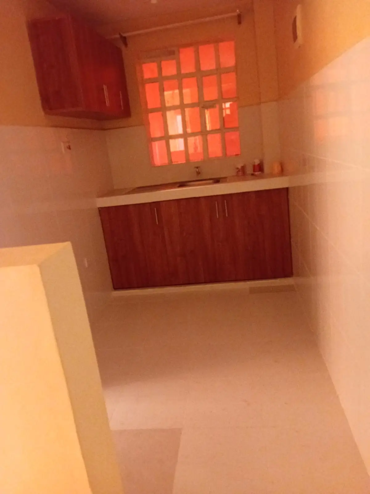 Red wooden kitchen cabinets with window and counter space