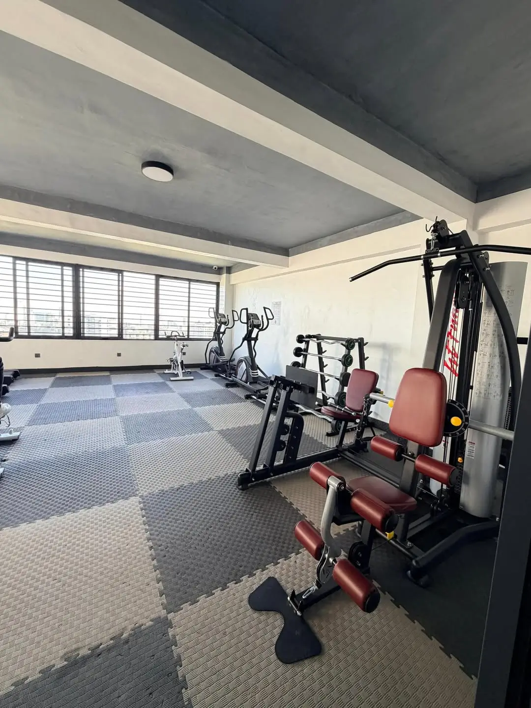 Modern gym with cardio equipment and weight machines