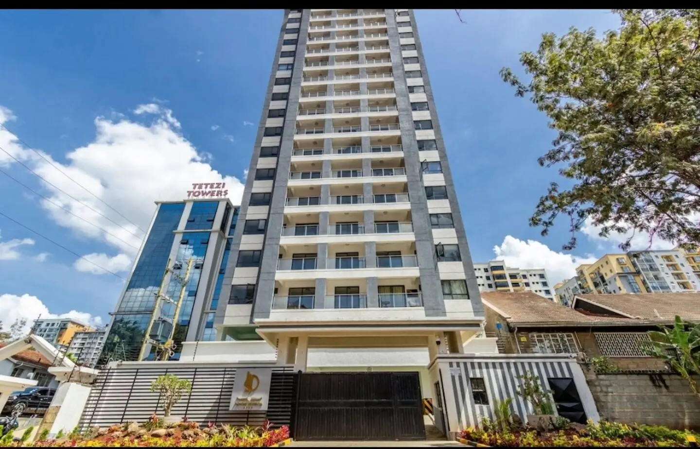 Modern residential tower with landscaped compound entrance