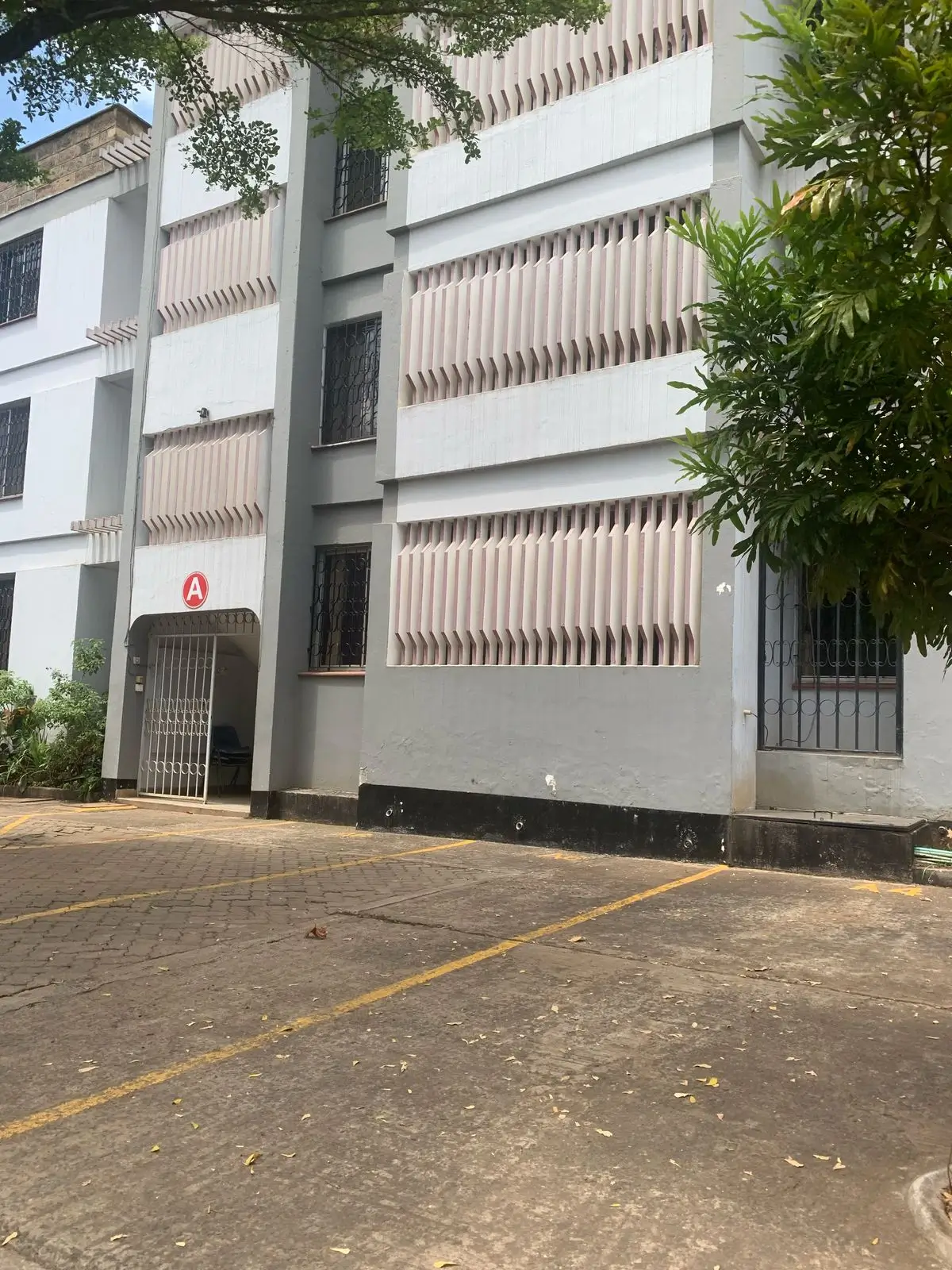 Modern apartment building facade with parking area